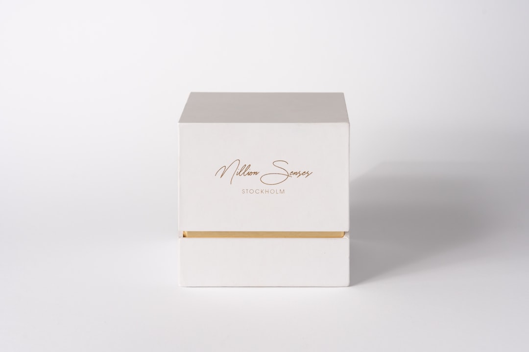 packaging design trends - A white box with gold accents on a white background.