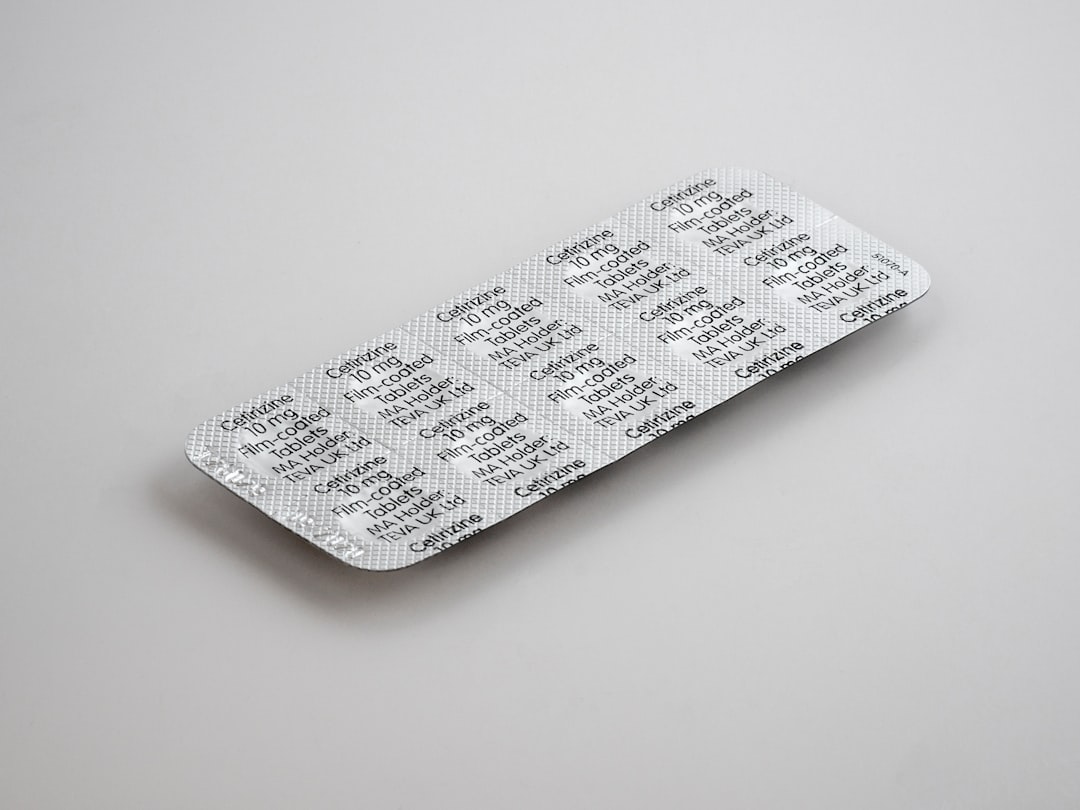 child-resistant packaging - gray blister pack on white surface