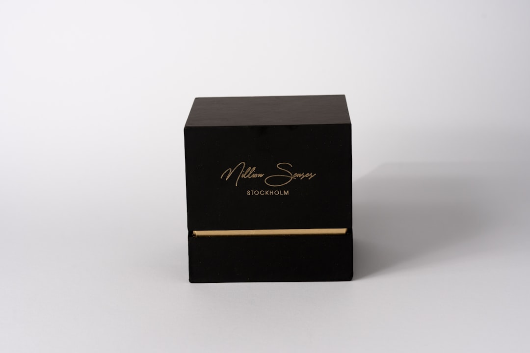 luxury packaging design - A black box with gold lettering on white background
