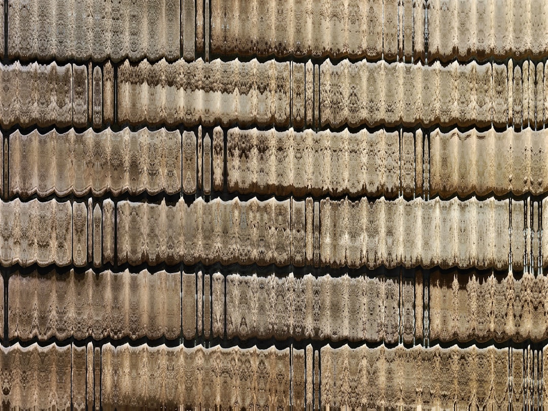 packaging cost optimization - Corrugated metal sheets stacked in a wall