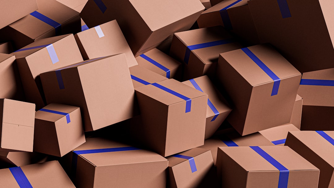 packaging supply chain - A large pile of brown cardboard boxes with blue tape.