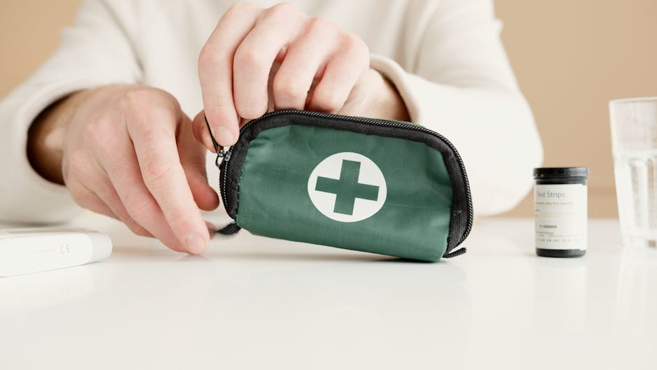 packaging testing - Close-up image of hands holding a first aid pouch on a table, with medical test strips nearby.