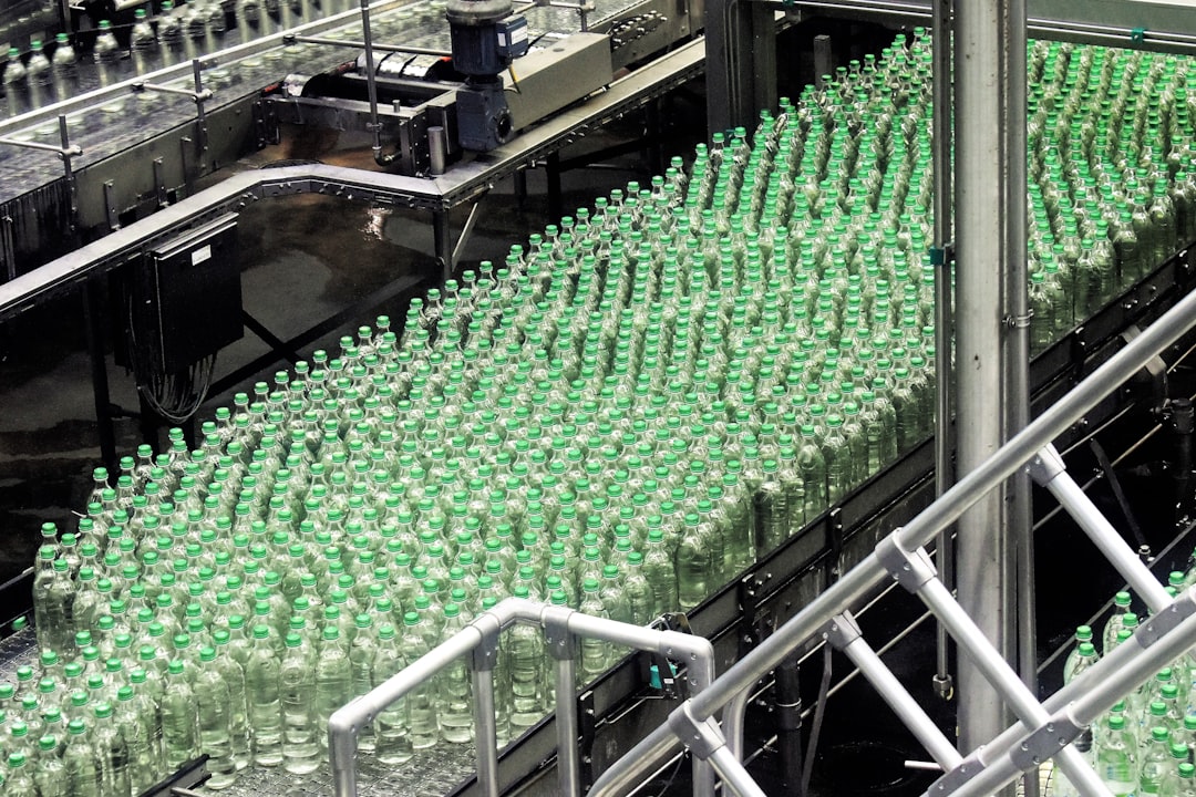 sustainable packaging materials - glass bottles on top of gray machine