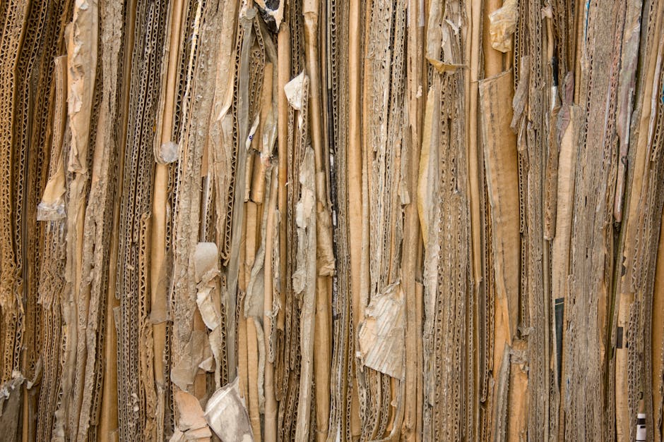 corrugated box specifications - Detailed view of stacked recyclable cardboard showing texture and patterns.
