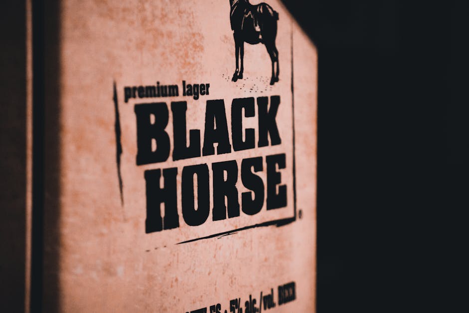 packaging typography - Close-up photo of Black Horse lager packaging with prominent text.