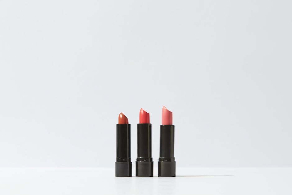 cosmetic packaging trends - A minimalist display of three lipsticks on a white background, perfect for cosmetic themes.