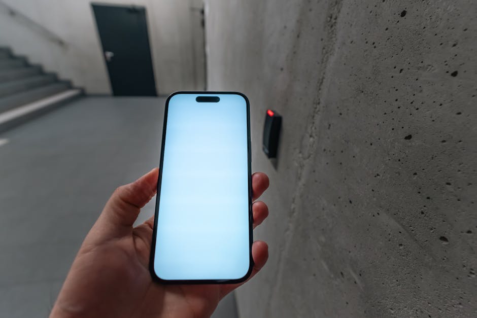 smart packaging technology - A smartphone unlocking a secure door using NFC technology in a modern building stairwell.