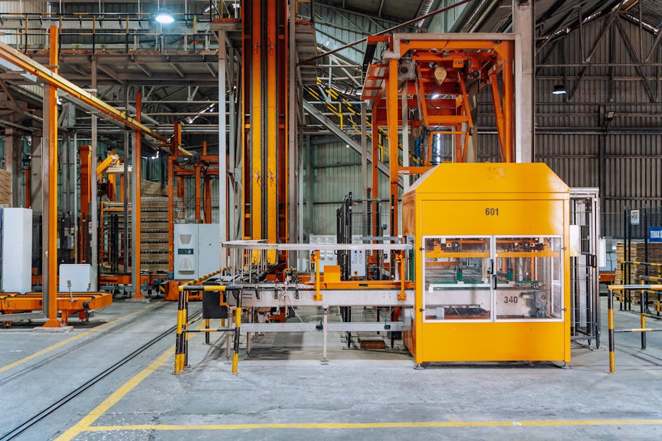 filling line optimization - Detailed view of machinery in an operational glass factory in Dar es Salaam.