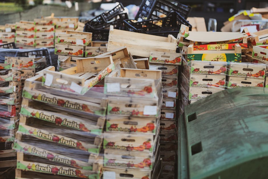 California EPR requirements - Piles of wooden fruit boxes in an outdoor market area, ideal for food or recycling themes.