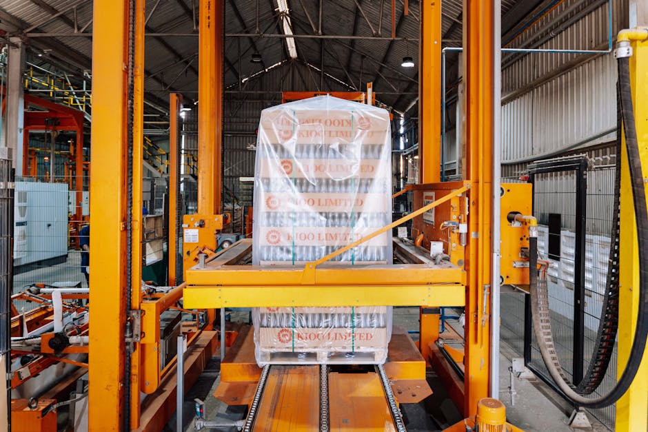packaging news May 2026 - An industrial machine in a glass factory showcasing automated packaging in Dar es Salaam.