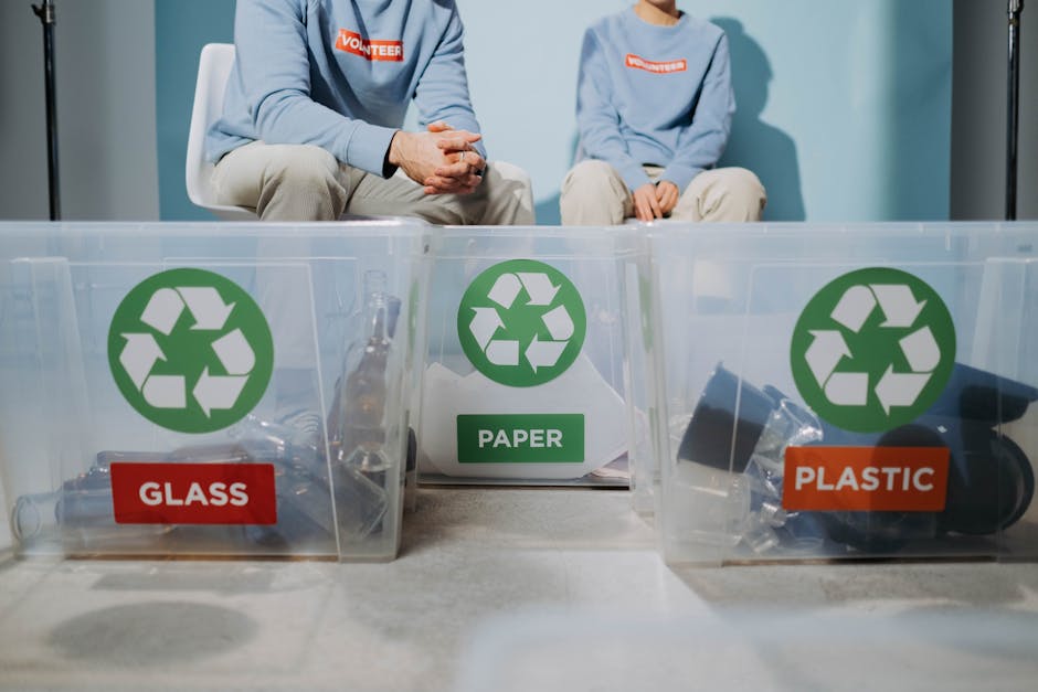 packaging news - Volunteers organize recyclables into glass, paper, and plastic bins to promote eco-friendly practices.