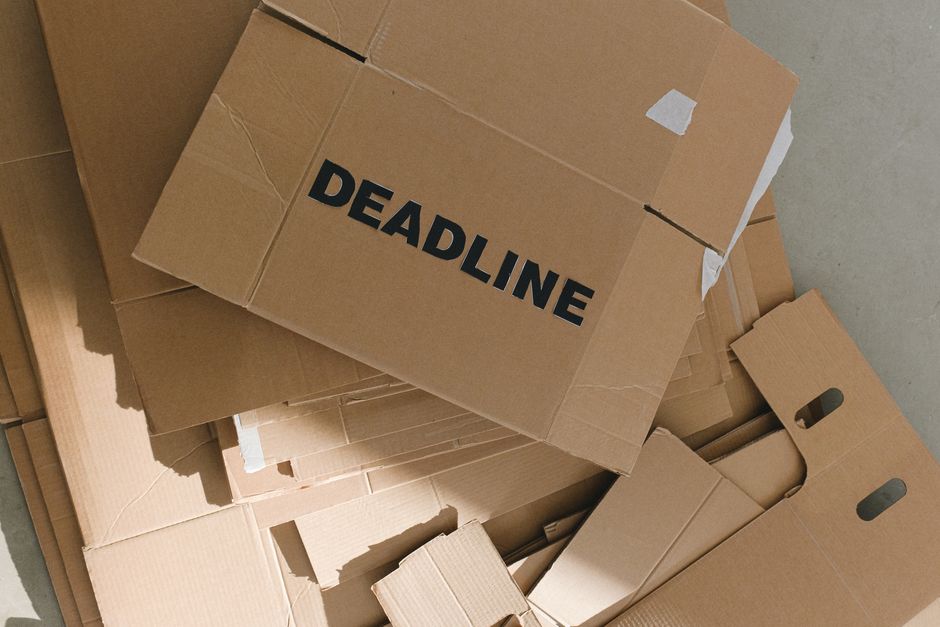 packaging industry news - Pile of cardboard boxes with bold 'Deadline' label indoors, emphasizing urgency.